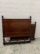 A mahogany antique single bedframe with carved acorn finials