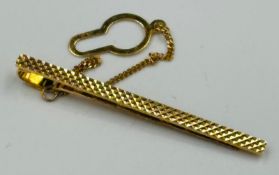 A 9ct yellow gold diamond cut tie pin on safety chain with an approximate total weight of 2.6g