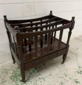 A mahogany canterbury magazine stand on castors and with single drawer under