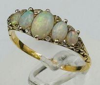 An opal and diamond set ring, set with five oval cabochon cut opals, measuring between 7.4mm x 5.