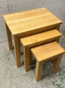 A light oak nest of tables (H53cm W55cm D40cm)