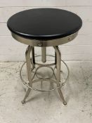 An industrial style adjustable bar stool