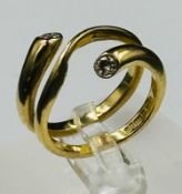 An 18ct gold snake style diamond ring with an approximate size O with diamonds at either end,