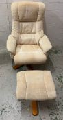 A beige swivel reclining chair and foot stool
