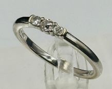 An 18ct gold three diamond ring, approximate weight 2.9g and size P.5