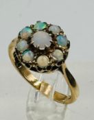 A 9ct opal daisy style ring, approximate size N with approximate weight 3.1g.