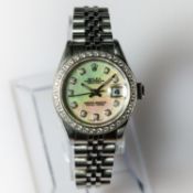 A Rolex Oyster Perpetual watch, round white mother of peral dial, diamond dot indices to diamond set