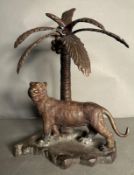 A cold cast bronze of a Bengal tiger under a palm tree