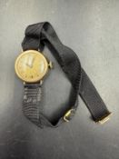 A 14ct gold ladies watch on ribbon bracelet.