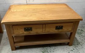 A rustic oak coffee table (H46cm W93cm D55cm)