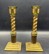 A pair of brass candlesticks with twisted steams and square base (H19cm)