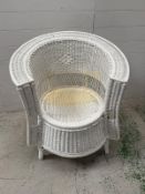 A white painted wicker garden chair