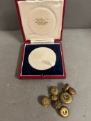 A cased metal and vintage buttons