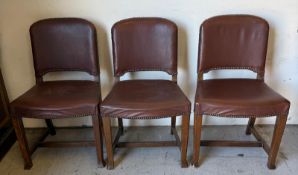 Three oak framed dining chairs with faux brown leather and brass studs