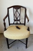 A George III mahogany elbow chair with well carved back and arms on reeded legs with cross stretcher