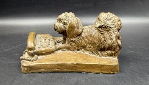 A resin sculpture of a dog and phone signed JOEL