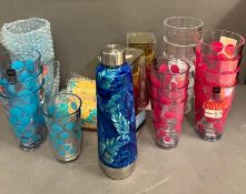 A selection of plastic picnic glasses and cups and flask