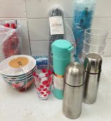 A selection of plastic picnic glasses, bowls and flasks