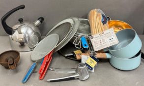 A selection of cookware to include two sieves, pans and a kettle