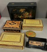 A selection of decorative lidded wooden boxes and display items