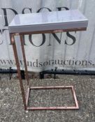 A single sofa table on a copper style frame with faux marble top