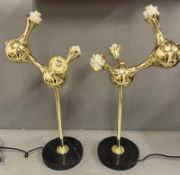 A pair of brass contemporary three arm table lamps