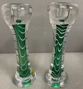 A pair of encased glass candlesticks