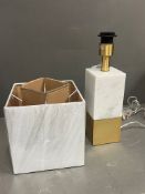 A white marble and brass style lamp with white shade