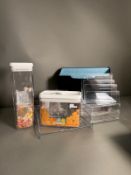 A selection of Perspex storage containers and a letter rack