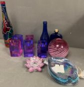 A collection of coloured glass to include candlesticks etc