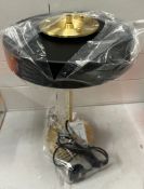 A contemporary black and gold table lamp