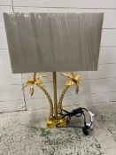 A palm tree shaped table lamp and shade