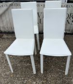 Four white dining chairs