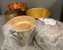 A selection of metal waste paper bins and candle holders