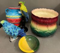A collection of vibrant china and ceramic items to include parrots