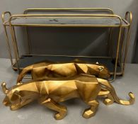 A little shelfing unit and two decorative leopards