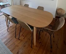 A contemporary dining suite comprising an oval dining table and six rattan chairs. (H74cm W213cm