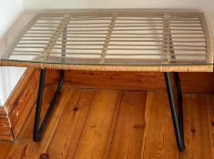 A rattan side table with glass top (H43cm W76cm D46cm)