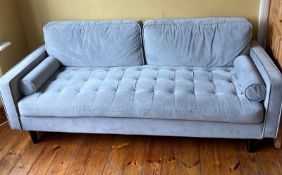 A three-seater sofa with buttoned seat, two back cushions and bolster cushions to each end. (H64cm