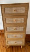 A tallboy chest of drawers with rattan-style drawer fronts. (H113cm W48cm D40cm)