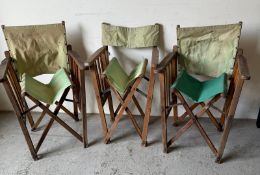 Three vintage folding director’s chairs.