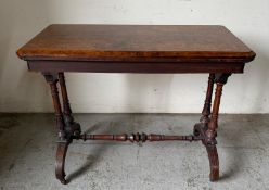 Burr walnut card table, the hinged top opening to a red-baize interior, raised on a twin-support