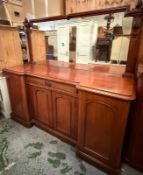 A mahogany sideboard, fitted with a central cupboard and drawer flanked by panelled doors, featuring