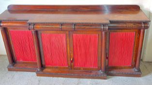 A Regency rosewood breakfront side cabinet, the doors lined with dark pink silk and fitted with