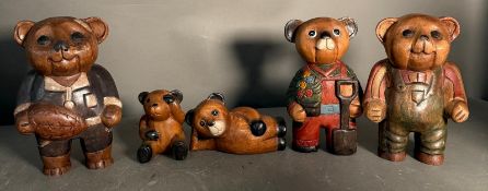 Five wooden ornamental bears to include Footballer bear, Reading bear and Drummer bear