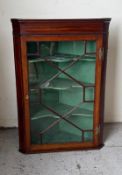 A mahogany astragal glazed corner cabinet with three shelves (H103cm W70cm D47cm)