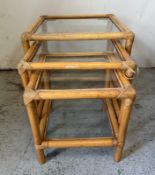 A nest of three bamboo style tables. Height 45cm x 49cm square largest.