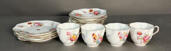 A part Coalport tea service on a floral pattern to include cups, saucers and side plates