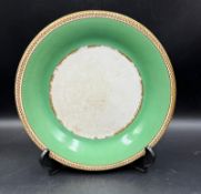 A plate from H.M.S Princess Royal in white, green and gilt with central stamp