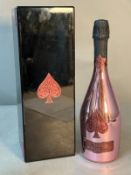 A bottle of Armand De Brignac brut rose champagne in black lacquer presentation box